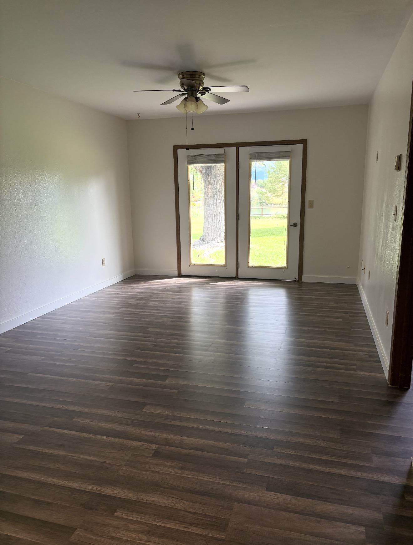 Unfurnished private apartment living room with patio doors at Spring Creek Chalet
