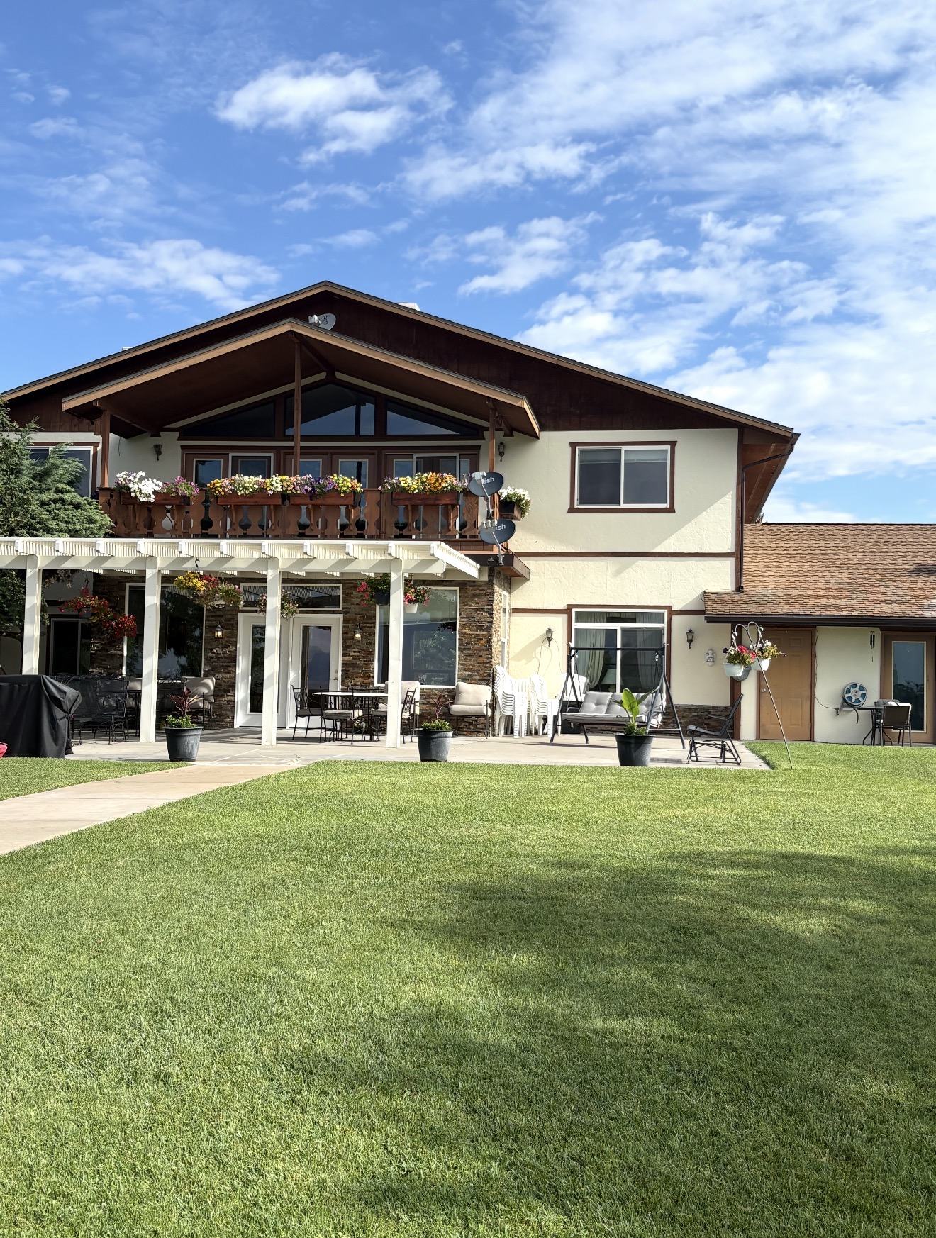 Chalet-style building, patio and wide green lawn