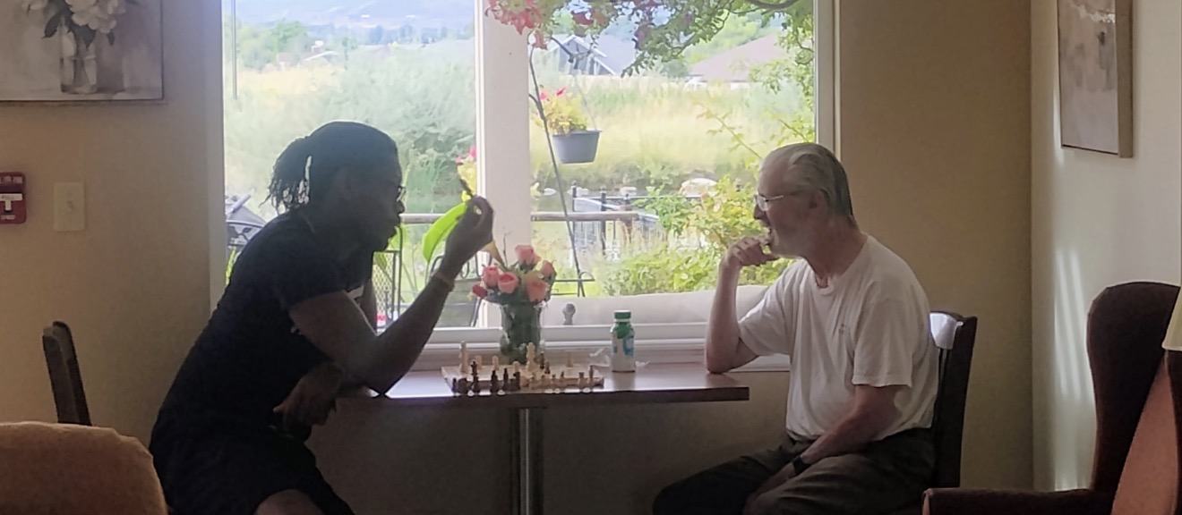 Residents playing chess together at Spring Creek Chalet